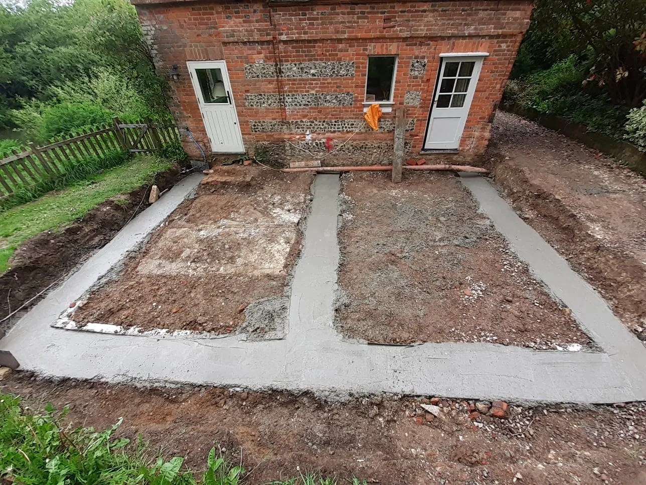 a brick building with a cement walkway in front of it