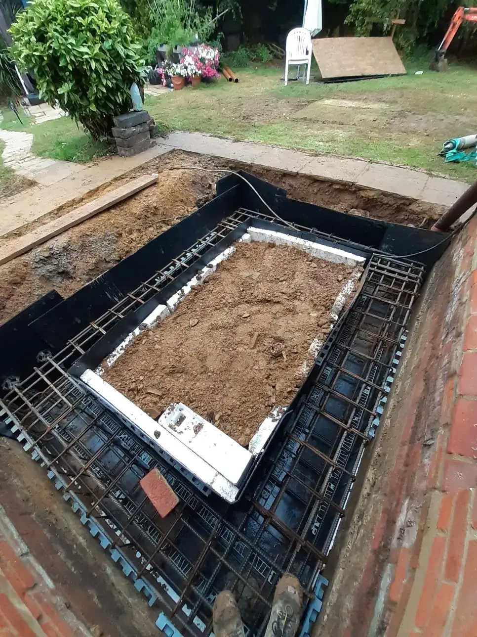 a metal grate with dirt on top of it