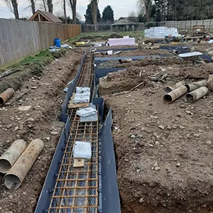 A construction site with pipes laying on the ground.