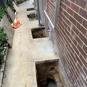 A brick wall with a hole in the middle of it.