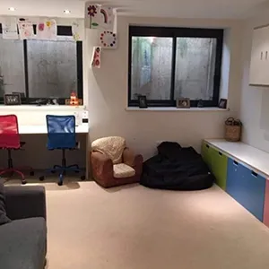 A living room filled with furniture and lots of windows.