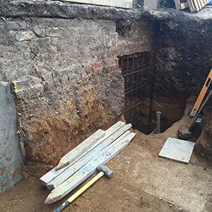 A construction site with a large hole in the ground.