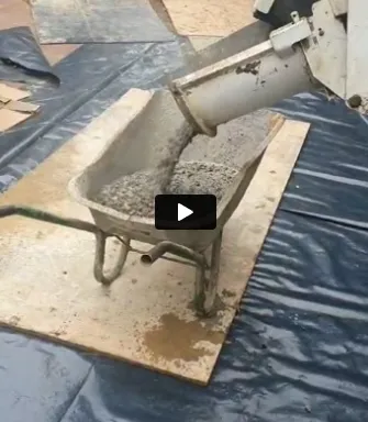 a machine is pouring cement into a bucket