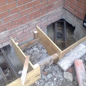 a brick building with a hole in the ground